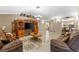 Living room with tiled floors, brown couches, and a large TV at 3273 Wentworth St, North Port, FL 34288