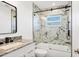 Bathroom featuring a granite vanity and marble tiled shower with glass door at 3446 Monica Pkwy, Sarasota, FL 34235