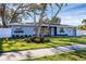 Charming home featuring a well-manicured lawn and flower boxes under the windows at 3446 Monica Pkwy, Sarasota, FL 34235