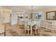 Bright dining area with glass-top table and white chairs, adjacent to kitchen at 3500 El Conquistador Pkwy # 252, Bradenton, FL 34210