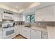 Well-equipped kitchen featuring white cabinets and stylish backsplash at 3500 El Conquistador Pkwy # 252, Bradenton, FL 34210