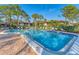 Community pool with lounge chairs and surrounding landscaping at 3500 El Conquistador Pkwy # 252, Bradenton, FL 34210