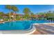 Sparkling community pool with ample lounge chairs for sunbathing at 3500 El Conquistador Pkwy # 252, Bradenton, FL 34210