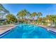 Relaxing community pool with plenty of lounge chairs at 3500 El Conquistador Pkwy # 252, Bradenton, FL 34210