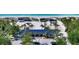 Aerial view of pristine beach with blue-roofed shelter, palm trees, and ocean at 3628 Fair Oaks Pl, Longboat Key, FL 34228