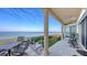 Spacious covered back porch offers a relaxing space with views of the water at 3628 Fair Oaks Pl, Longboat Key, FL 34228