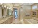 Luxurious bathroom with double vanities, soaking tub, and stylish fixtures at 3628 Fair Oaks Pl, Longboat Key, FL 34228