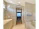 Well-lit bathroom featuring a shower, tub, and views to the bedroom at 3628 Fair Oaks Pl, Longboat Key, FL 34228