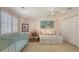 Comfortable bedroom with soft colors, a crib, and ample closet space at 3628 Fair Oaks Pl, Longboat Key, FL 34228