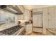 Close up shot of a kitchen with stainless steel appliances, custom cabinetry, and granite countertops in a cozy layout at 3628 Fair Oaks Pl, Longboat Key, FL 34228