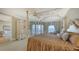 Sumptuous main bedroom showcasing waterfront views, a seating nook, a canopy bed and sophisticated decor at 3628 Fair Oaks Pl, Longboat Key, FL 34228