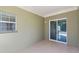 Covered back patio with sliding glass doors and tile flooring at 3711 20Th E St, Bradenton, FL 34208