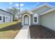 Modern front entryway with arched doorway and walkway at 3711 20Th E St, Bradenton, FL 34208