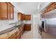 Kitchen boasts wood cabinets, granite countertops, and stainless steel appliances at 3711 20Th E St, Bradenton, FL 34208