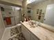 Well-lit bathroom featuring a wide counter with a large mirror and shower with sliding glass doors at 3739 Collins St # 701, Sarasota, FL 34232