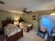 Comfortable bedroom with twin beds, floral accents, a ceiling fan, and classic wooden furniture at 3739 Collins St # 701, Sarasota, FL 34232