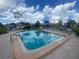 Community pool surrounded by lounge chairs and tables, perfect for relaxing and socializing at 3739 Collins St # 701, Sarasota, FL 34232