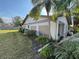 Lawn view of side of home showing windows and side carport entry at 3739 Collins St # 701, Sarasota, FL 34232