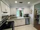 Well-lit kitchen featuring stainless steel appliances, white cabinetry, and an open design at 3739 Collins St # 701, Sarasota, FL 34232