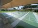 Covered shuffleboard courts in a well-maintained community with benches for spectators at 3739 Collins St # 701, Sarasota, FL 34232