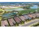 Aerial view of homes and community featuring lakes, golf course, and manicured landscaping at 3860 Santa Caterina Blvd, Bradenton, FL 34211