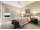 Bedroom with bedside tables, woven bench, neutral decor, and large window at 3860 Santa Caterina Blvd, Bradenton, FL 34211