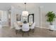 Modern dining room with round table, white chairs, and stylish lighting at 3860 Santa Caterina Blvd, Bradenton, FL 34211