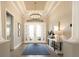 Bright foyer with chandelier, patterned rug, white trim, and tile floors at 3860 Santa Caterina Blvd, Bradenton, FL 34211