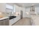 Well-lit kitchen showcasing white cabinets, a stainless steel refrigerator, a black sink, and modern appliances at 3860 Santa Caterina Blvd, Bradenton, FL 34211