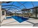 Screened-in pool area with a sparkling pool, sun loungers, and lush landscaping at 3860 Santa Caterina Blvd, Bradenton, FL 34211