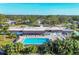 Aerial view of community pool, clubhouse, and lush landscaping at 3990 Overlook Bnd # 19, Sarasota, FL 34232