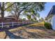 Landscaped backyard with a long grass area and privacy fence at 3990 Overlook Bnd # 19, Sarasota, FL 34232