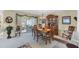 Bright dining room with wood table and hutch, and view to a relaxing screened porch at 3990 Overlook Bnd # 19, Sarasota, FL 34232