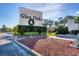 Glen Oaks community entrance, featuring a landscaped sign with a holiday wreath at 3990 Overlook Bnd # 19, Sarasota, FL 34232