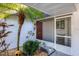 Inviting entryway with a screened door and lush tropical plants at 3990 Overlook Bnd # 19, Sarasota, FL 34232