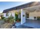 Covered entryway of a light-colored home with mature landscaping at 3990 Overlook Bnd # 19, Sarasota, FL 34232