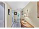 Bright hallway with a wooden console table and artwork at 3990 Overlook Bnd # 19, Sarasota, FL 34232