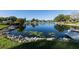 Serene lake with lush vegetation and community buildings in background at 3990 Overlook Bnd # 19, Sarasota, FL 34232