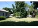 Large backyard with mature trees and grassy area at 421 Cleveland Dr, Sarasota, FL 34236