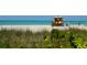 Lifeguard stand on beach with people enjoying the sun at 421 Cleveland Dr, Sarasota, FL 34236