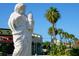 White statue of a Personal on a street with palm trees and shops at 421 Cleveland Dr, Sarasota, FL 34236