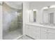 Modern bathroom with a spacious glass shower, dual sinks, marble countertops, and white vanities at 4244 Reflections Pkwy, Sarasota, FL 34233