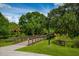 Community bridge amid green trees, grass, and blue skies, inviting residents for a peaceful walk at 4244 Reflections Pkwy, Sarasota, FL 34233