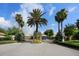 Community entrance featuring stately palm trees and landscaping welcomes residents and guests at 4244 Reflections Pkwy, Sarasota, FL 34233