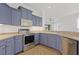 Well-lit kitchen featuring blue cabinetry, stainless steel appliances, and ample counter space for food preparation at 4244 Reflections Pkwy, Sarasota, FL 34233