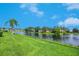 Scenic lake view with lush green lawn and beautiful blue sky at 4244 Reflections Pkwy, Sarasota, FL 34233