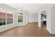 Bright living room with big windows, showcasing the light wood-style flooring and an open floorplan at 4244 Reflections Pkwy, Sarasota, FL 34233