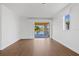 Living room features wood floors, neutral walls, and screened lanai access at 4244 Reflections Pkwy, Sarasota, FL 34233