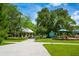 A view of the park's paved walkway, a gazebo, a sign explaining the history and a playground with mature shade trees at 4244 Reflections Pkwy, Sarasota, FL 34233