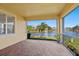 Screened patio with brick floors and a view of the water at 4244 Reflections Pkwy, Sarasota, FL 34233